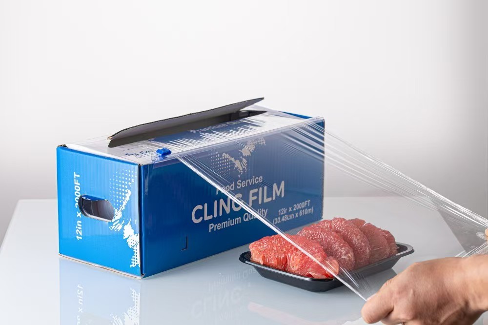 Pulling cling film from a cutter box over a tray