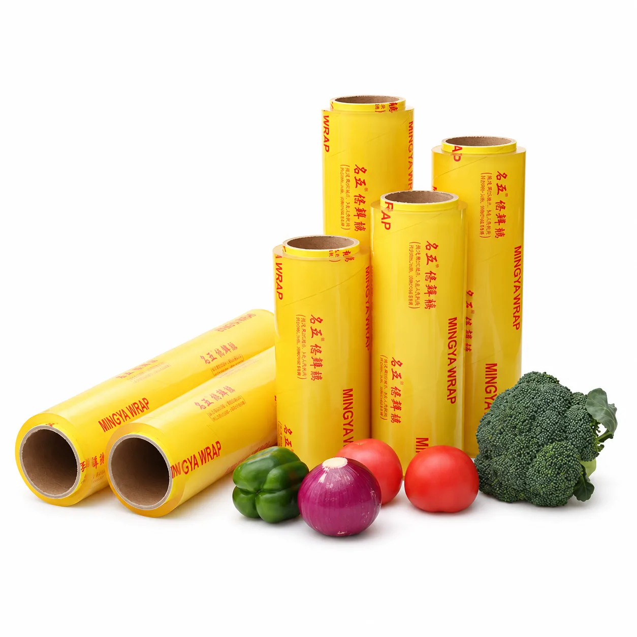 Packaged cling film rolls displayed with vegetables